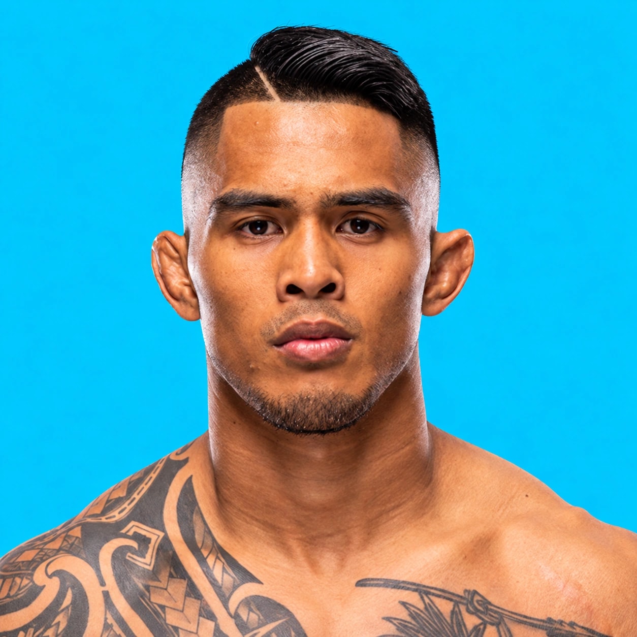 Kai Kamaka III headshot against a bright blue background